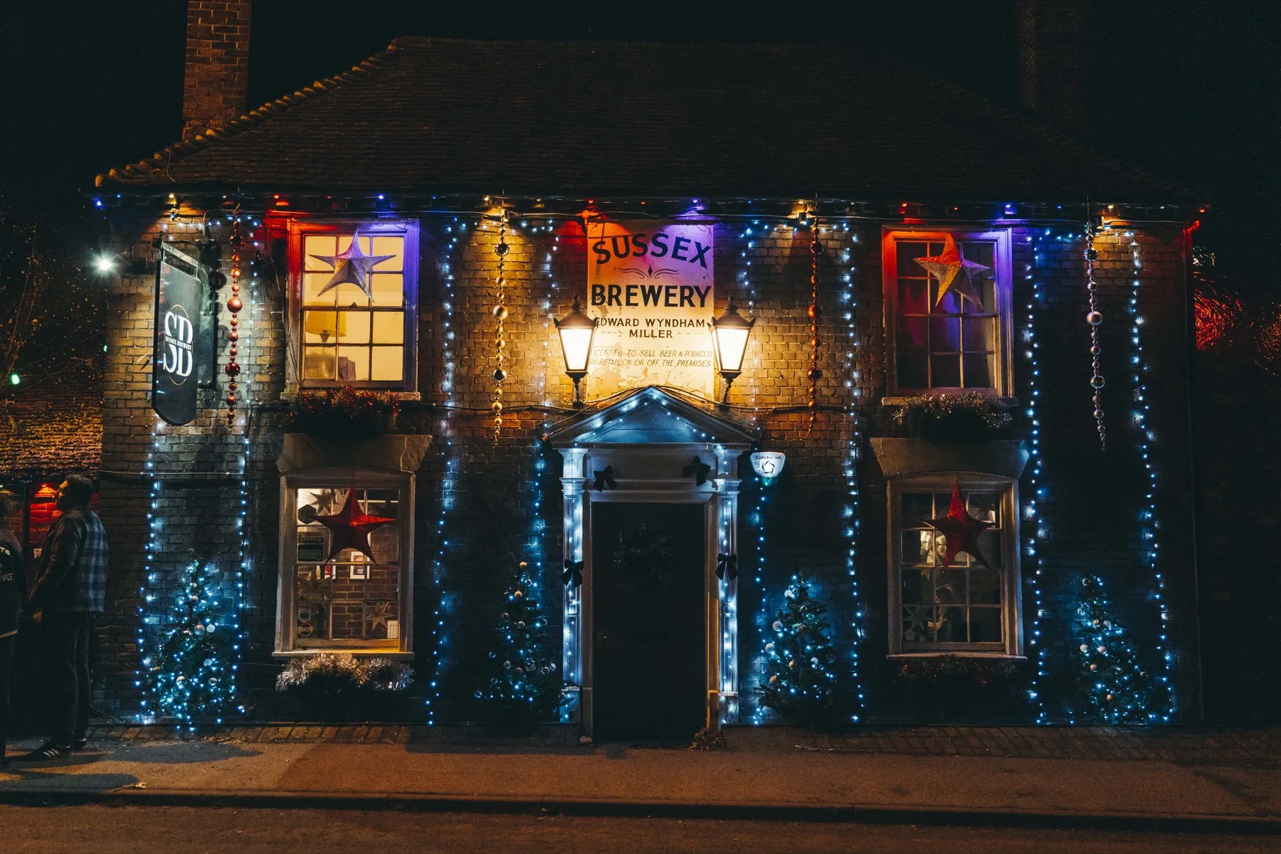 The Sussex Brewery lit up at night, dressed for Christmas